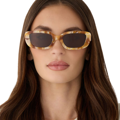 on model - female wearing diff eyewear featuring the daphne rectangle sunglasses with a gilded tortoise outside and courtside ivory white inside acetate frame and brown polarized lenses front view