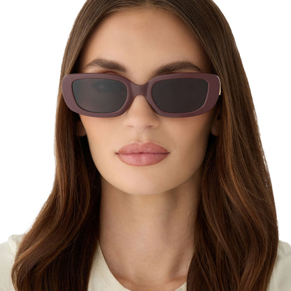 on model - female wearing diff eyewear featuring the daphne rectangle sunglasses with a rugby red acetate frame and grey polarized lenses front view
