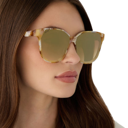 on model - female wearing diff eyewear gia square oversized sunglasses with a gilded tortoise acetate frame and brown gradient with light gold flash lenses angled view