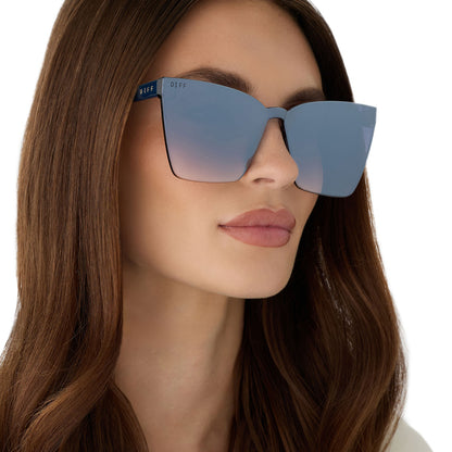 on model - female wearing diff eyewear featuring the goldie cateye sunglasses with a clubhouse blue frame and slate gradient flash lenses angled view