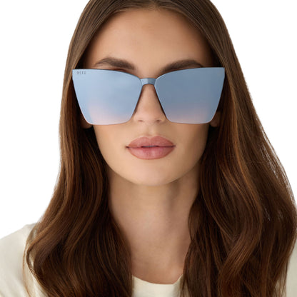 on model - female wearing diff eyewear featuring the goldie cateye sunglasses with a clubhouse blue frame and slate gradient flash lenses front view