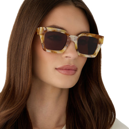 on model - female wearing diff eyewear featuring the greer square sunglasses with a gilded tortoise frame and brown polarized lenses angled view