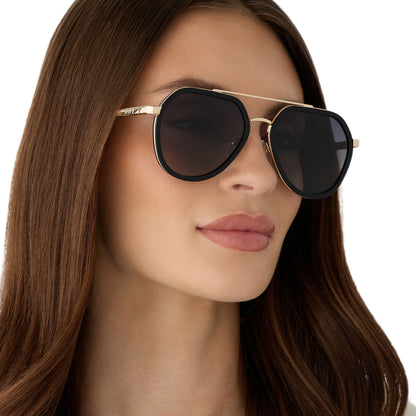 on model - female wearing diff eyewear featuring the joey round sunglasses with a black & gold metal frame with grey gradient polarized lenses angled view
