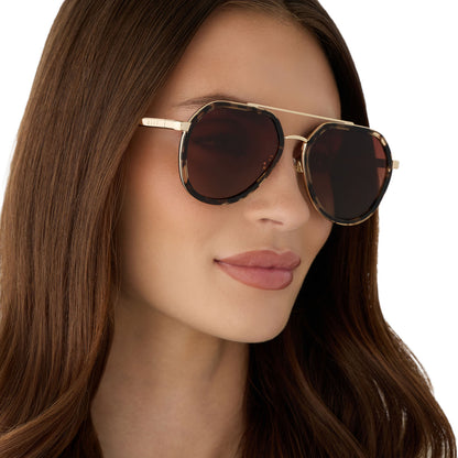on model - female wearing diff eyewear featuring the joey round sunglasses with a espresso tort & gold metal frame with brown gradient polarized lenses angled view