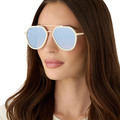 on model - female wearing diff eyewear featuring the joey round sunglasses with a courtside ivory & gold metal frame with blue slate gradient flash lenses angled view