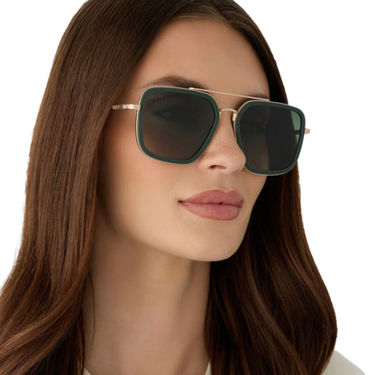 on model - female wearing diff eyewear featuring the jordan navigator sunglasses with a fairway green and gold metal frame with aloe green gradient polarized lenses angled view
