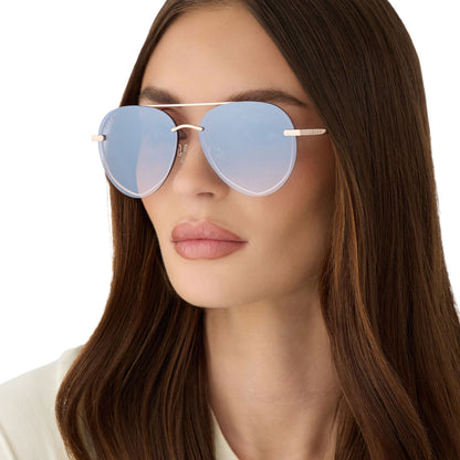 on model - female wearing diff eyewear featuring the lenox xs aviator sunglasses with a champagne gold (light gold) frame and blue slate gradient with silver flash lenses detailed view
