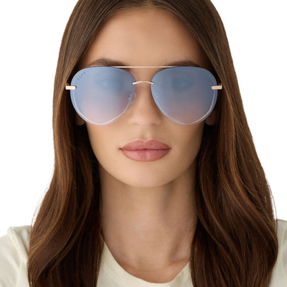 on model - female wearing diff eyewear featuring the lenox aviator sunglasses with a champagne gold (light gold) frame and blue slate gradient flash lenses front view