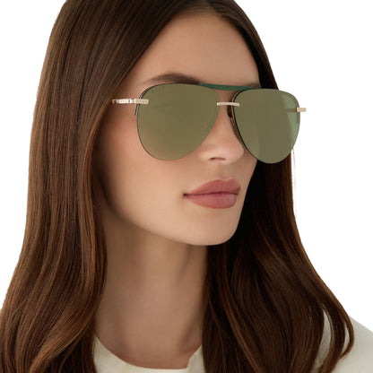 on model - female wearing diff eyewear featuring the tahoe aviator sunglasses with a gold metal and green accent frame with a aloe green gradient and light gold flash polarized sunglasses angled view