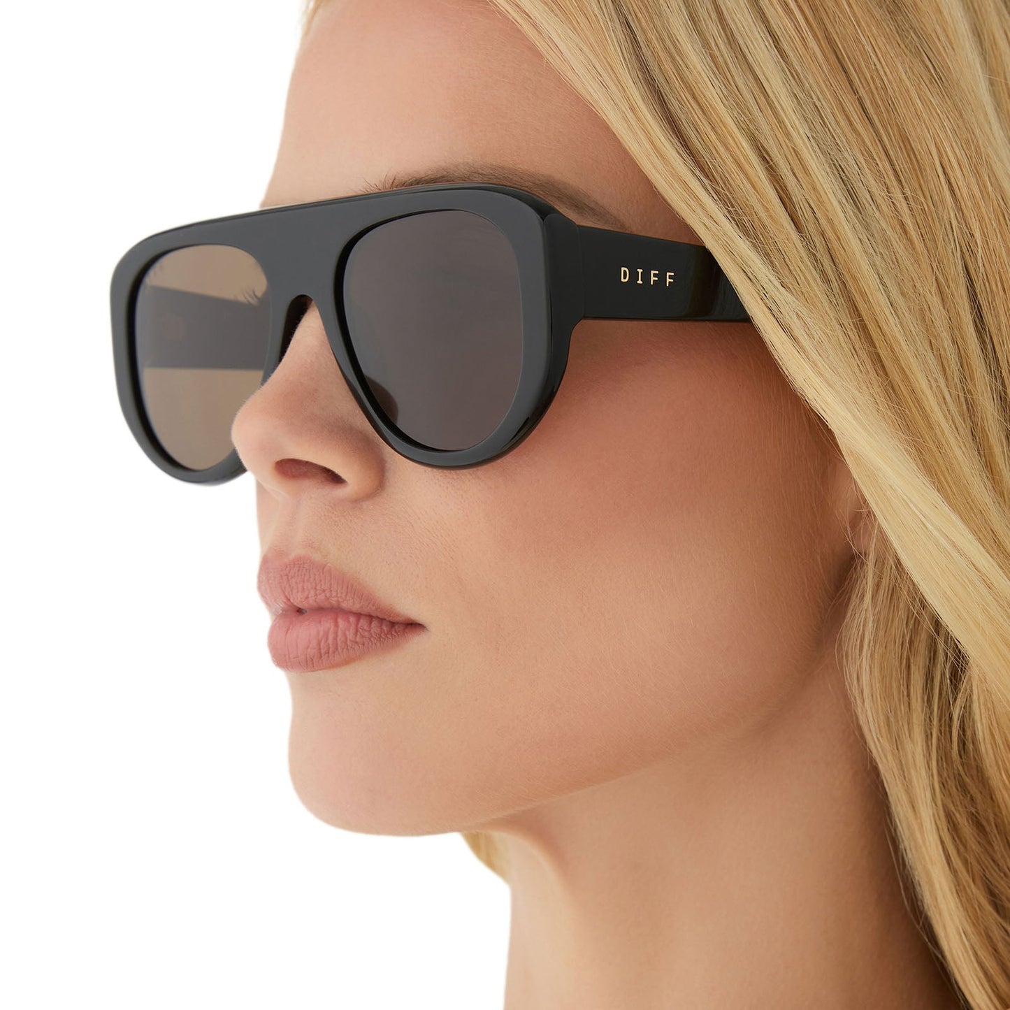 on model - female wearing diff eyewear featuring the morgan shield sunglasses with a black frame and brown lenses detailed view