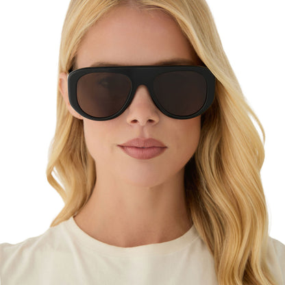on model - female wearing diff eyewear featuring the morgan shield sunglasses with a black frame and brown lenses front view
