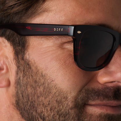 on model - male wearing diff eyewear mercer square sunglasses with a redwood acetate frame and grey polarized lenses detailed view