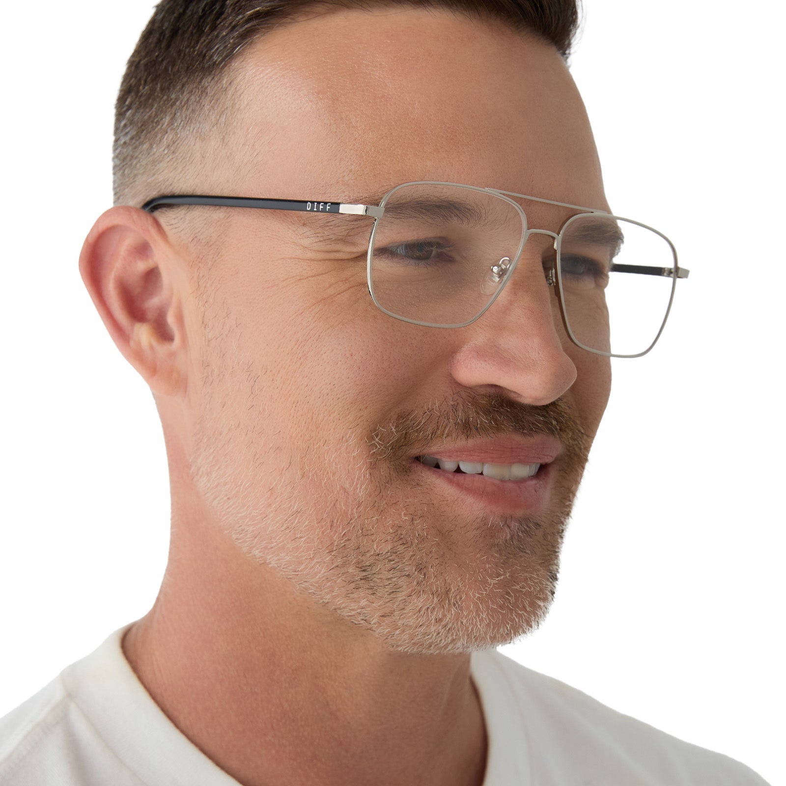 on model - male wearing yellowstone x diff eyewear featuring the rip wheeler navigator prescription glasses with a silver frame angled view