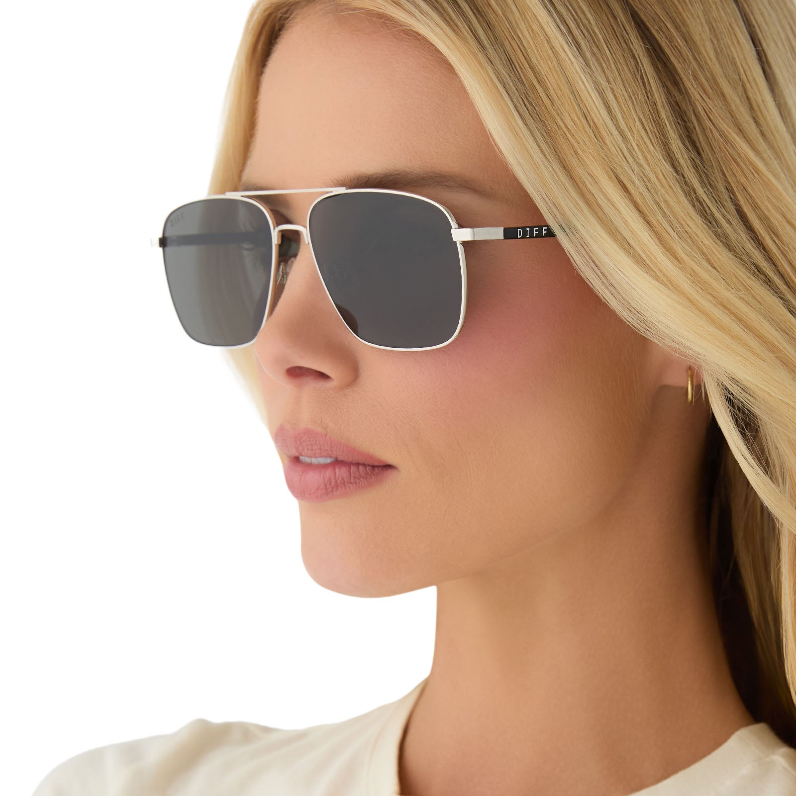 on model - female wearing yellowstone x diff eyewear featuring the rip wheeler navigator sunglasses with a silver frame and grey polarized lenses angled view