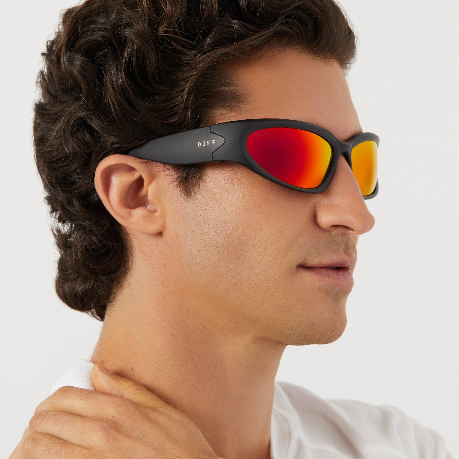 on model - male wearing diff sport side out wrap sunglasses with a matte black frame and sunset mirror polarized lenses