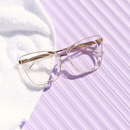 still life of diff eyewear the becky iv cat eye prescription glasses with a clear crystal with gold frame front view