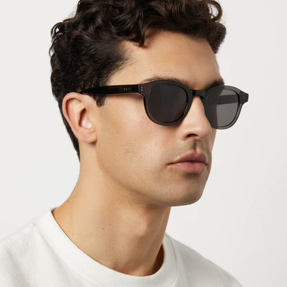 on model - male wearing diff eyewear featuring the arlo xl round sunglasses with a black smoke crystal frame and grey polarized lenses detailed view