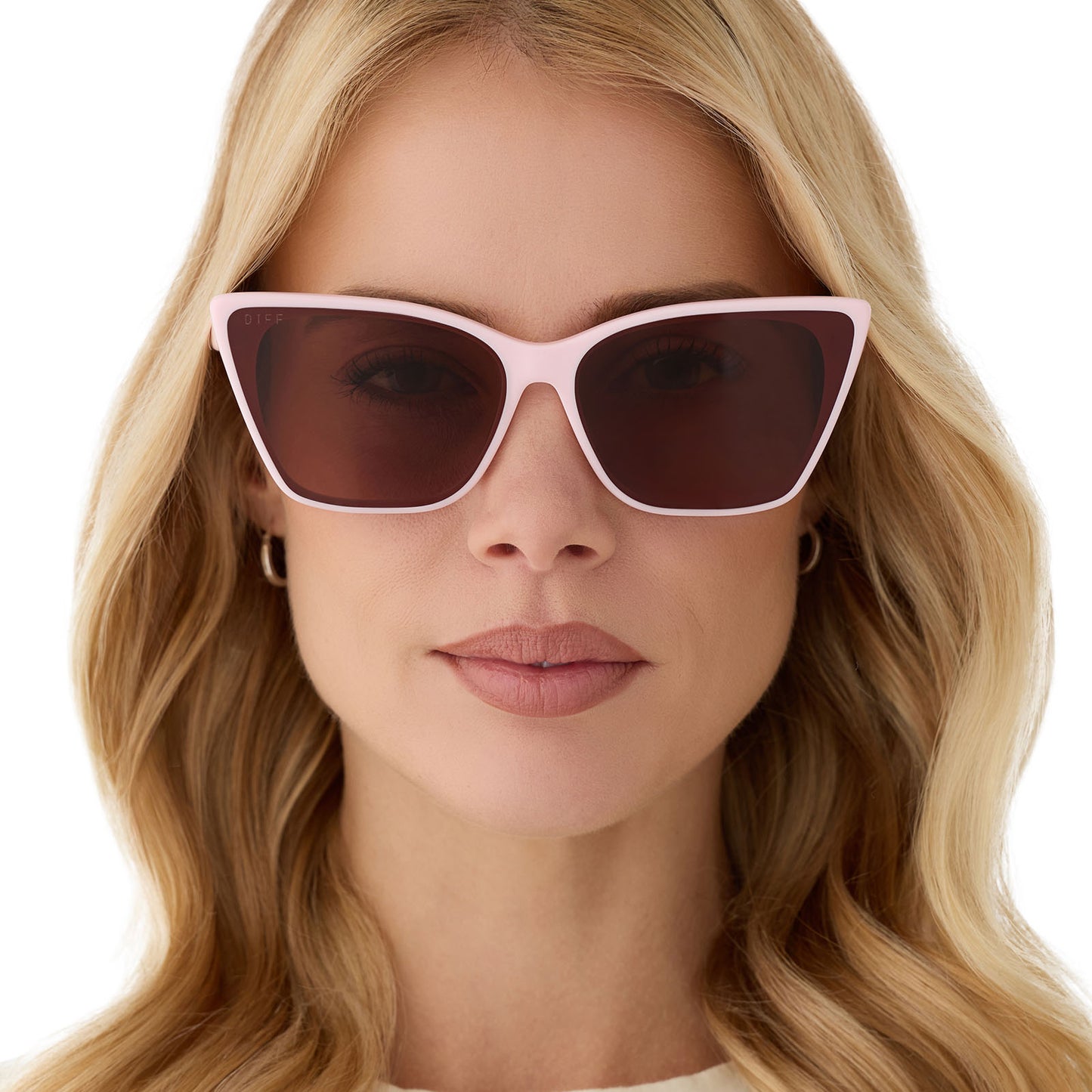 on model - female wearing diff eyewear featuring the alina cat eye sunglasses with a powder pink frame and brown lenses front view