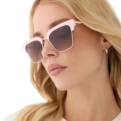 on model - female wearing diff eyewear featuring the capri rectangle sunglasses with a powder pink with champagne frame and brown gradient lenses angled view