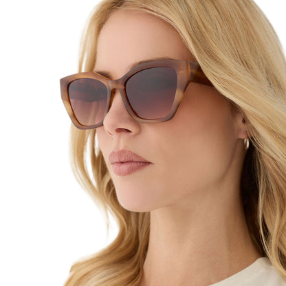 on model - female wearing diff eyewear featuring the evie cat eye sunglasses with a tawny brown tortoise frame and brown gradient lenses angled view