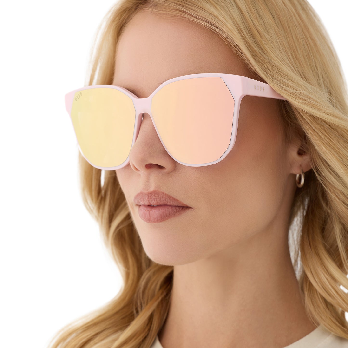 on model - female wearing diff eyewear featuring the gia square sunglasses with a powder pink frame and cherry blossom mirror lenses detailed view