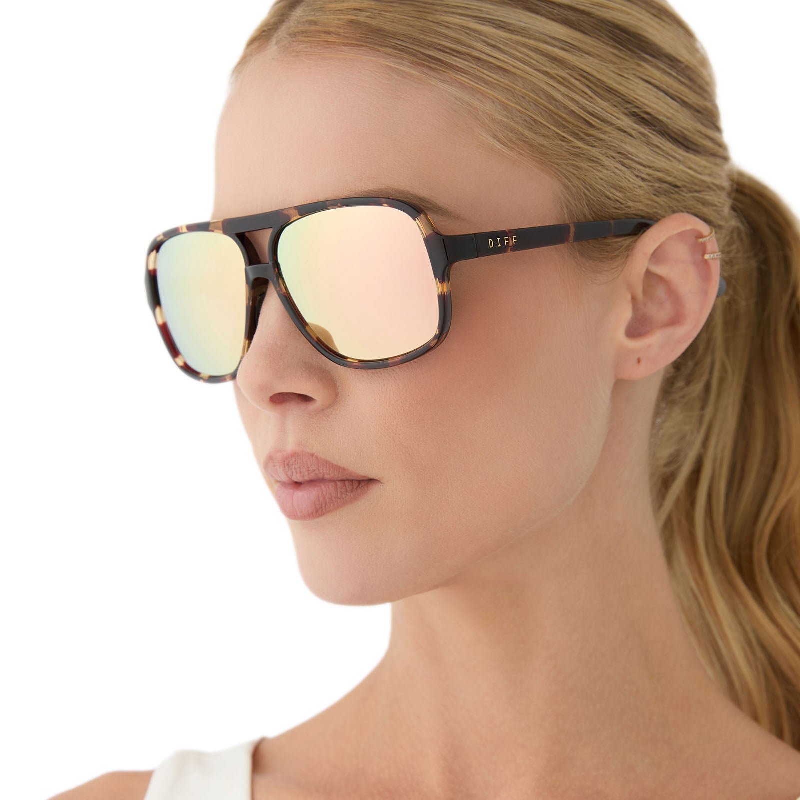 on model - female wearing diff sport featuring the hangtime aviator sunglasses with a sport tortoise frame and champagne mirror polarized lenses angled view