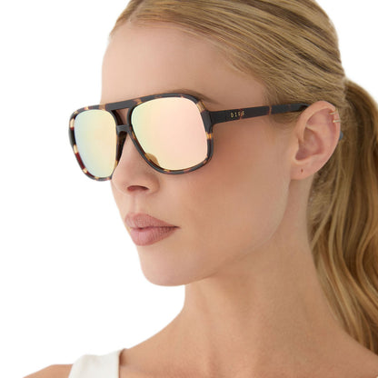 on model - female wearing diff sport featuring the hangtime aviator sunglasses with a sport tortoise frame and champagne mirror polarized lenses angled view