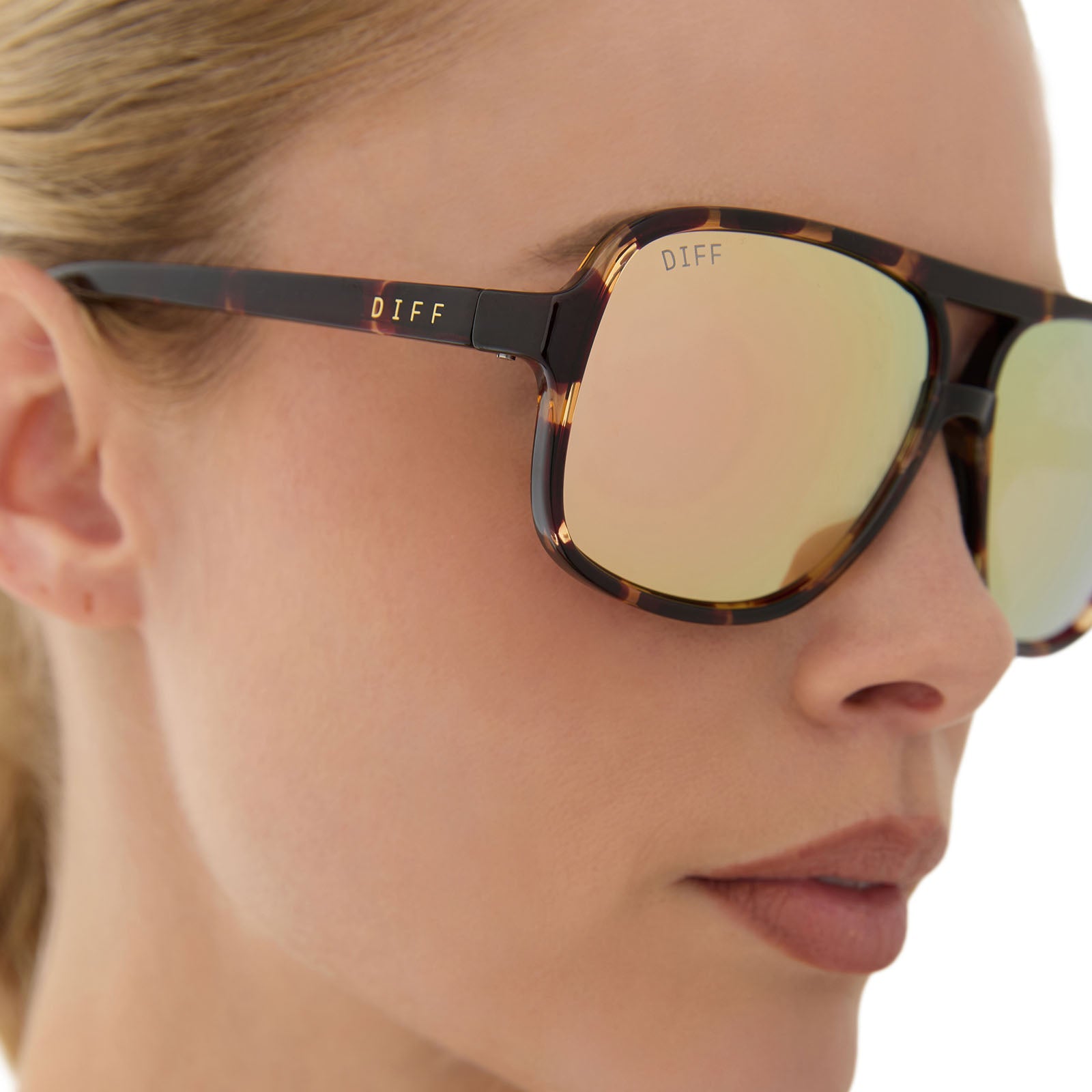 on model - female wearing diff sport featuring the hangtime aviator sunglasses with a sport tortoise frame and champagne mirror polarized lenses detailed view
