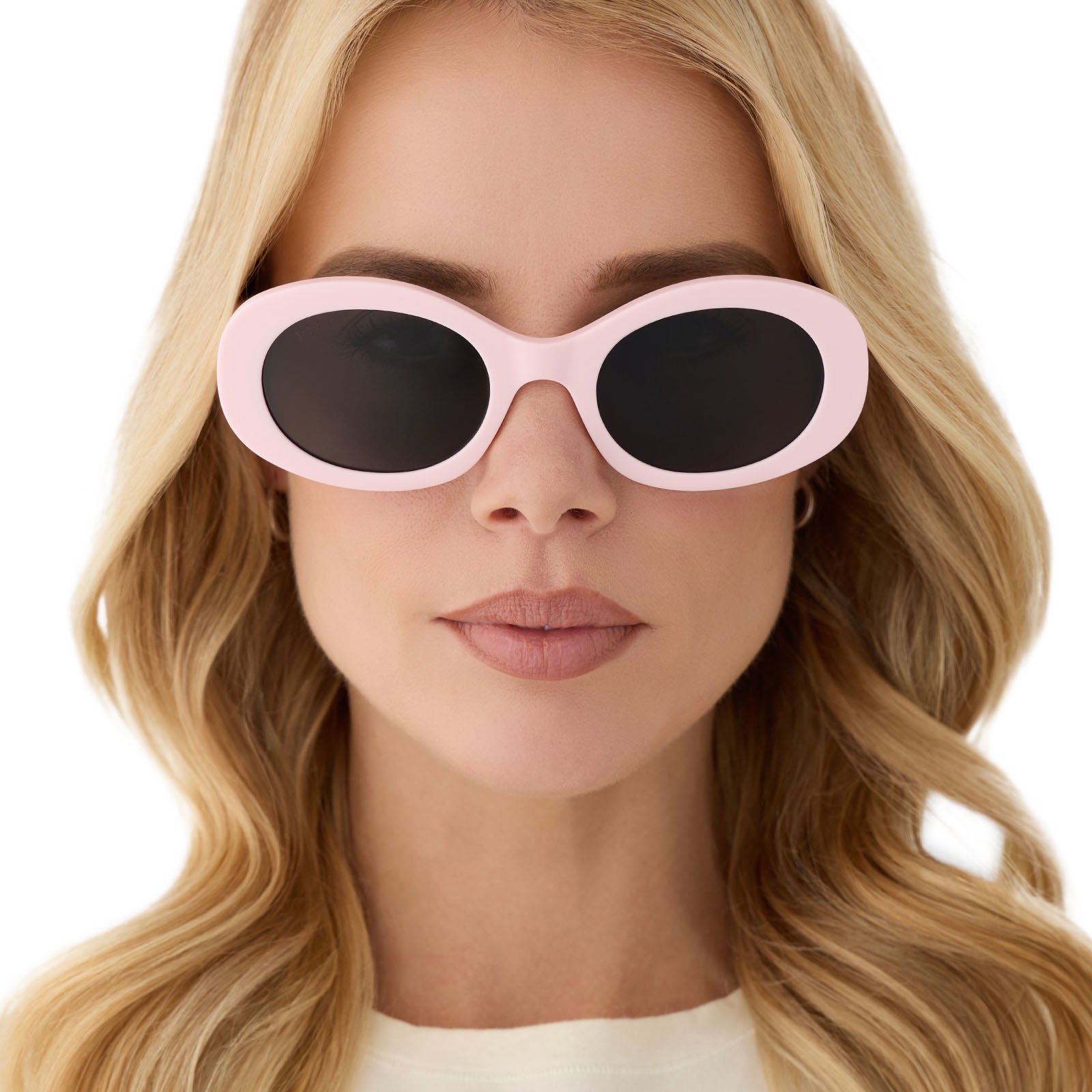on model - female wearing diff eyewear featuring the lainey oval sunglasses with a powder pink frame and grey polarized lenses front view