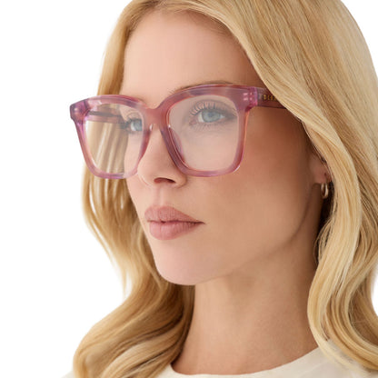 on model - blonde female wearing diff eyewear featuring the meredith square prescription glasses with a fleur pink tortoise frame angled view