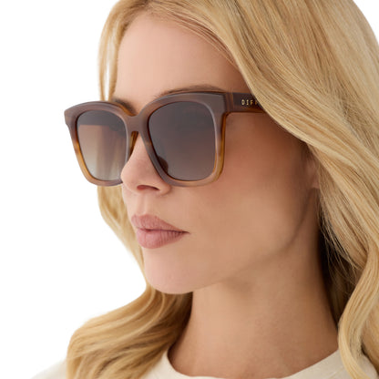 on model - female wearing diff eyewear featuring the meredith square sunglasses with a tawny brown tortoise frame and brown gradient polarized lenses angled view