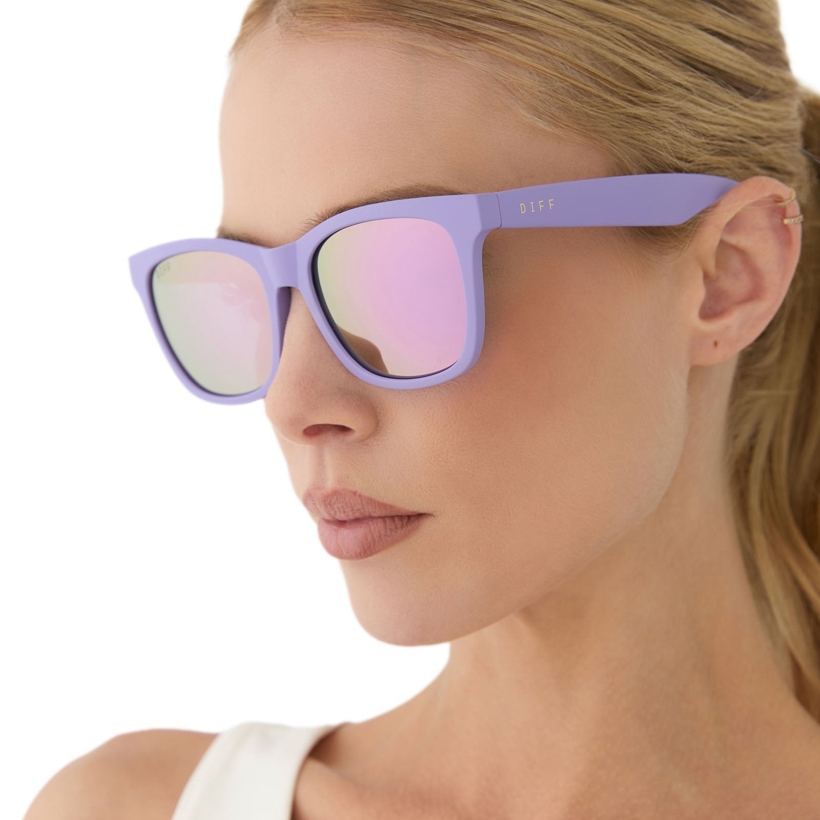 on model - female wearing diff sport featuring the storm square sunglasses with a matte lavender frame and lavender mirror polarized lenses angled view