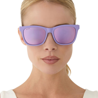 on model - female wearing diff sport featuring the storm square sunglasses with a matte lavender frame and lavender mirror polarized lenses front view