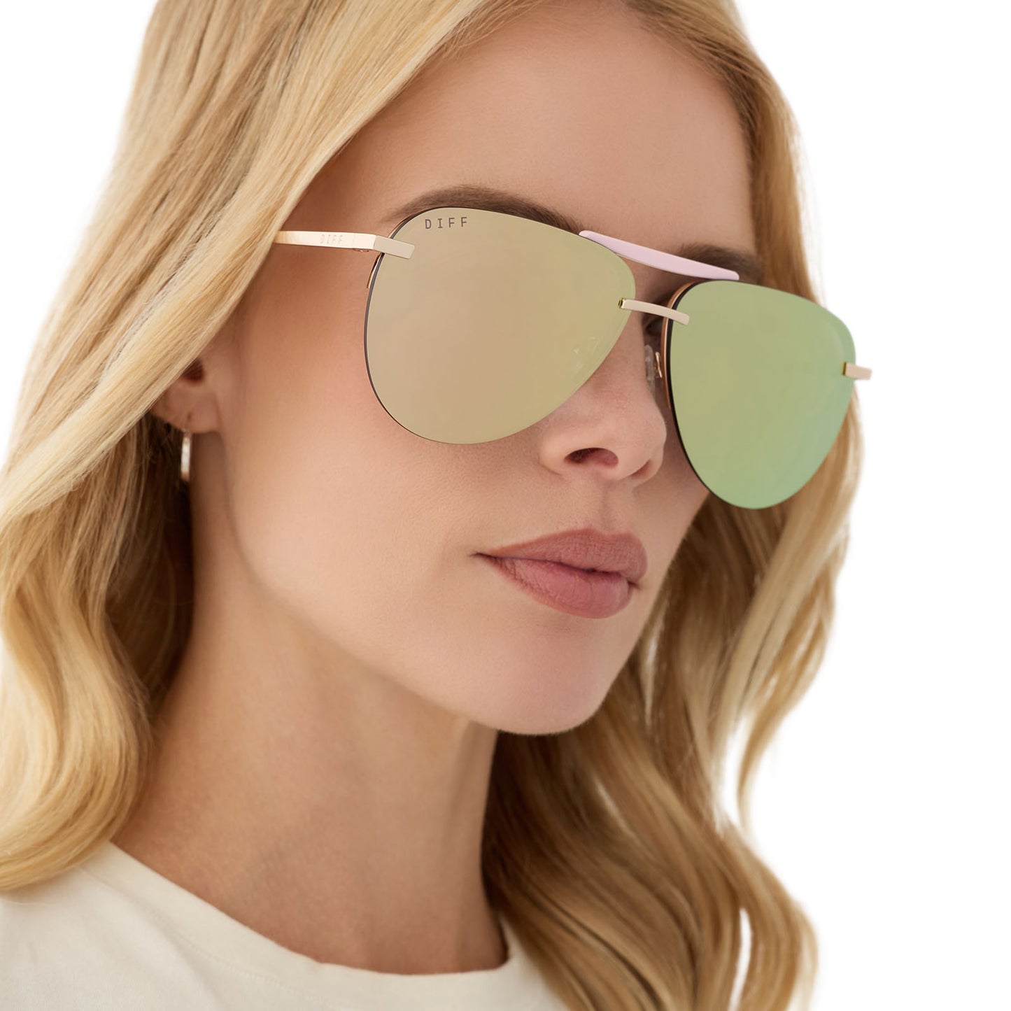 on model - female wearing diff eyewear featuring the tahoe aviator sunglasses with a gold with powder pink brow bar & temple tips frame and taupe mirror lenses angled view