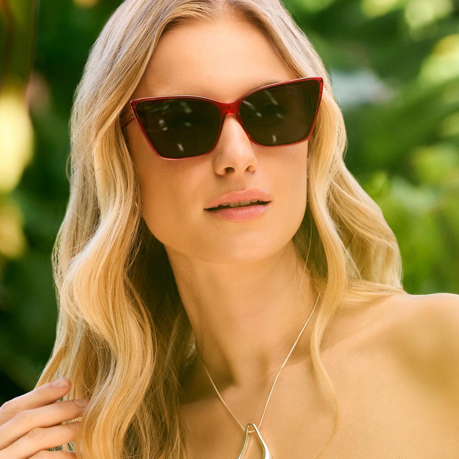 on model - female wearing diff eyewear featuring the alina cat eye sunglasses with a red hot summer frame and grey lenses front view