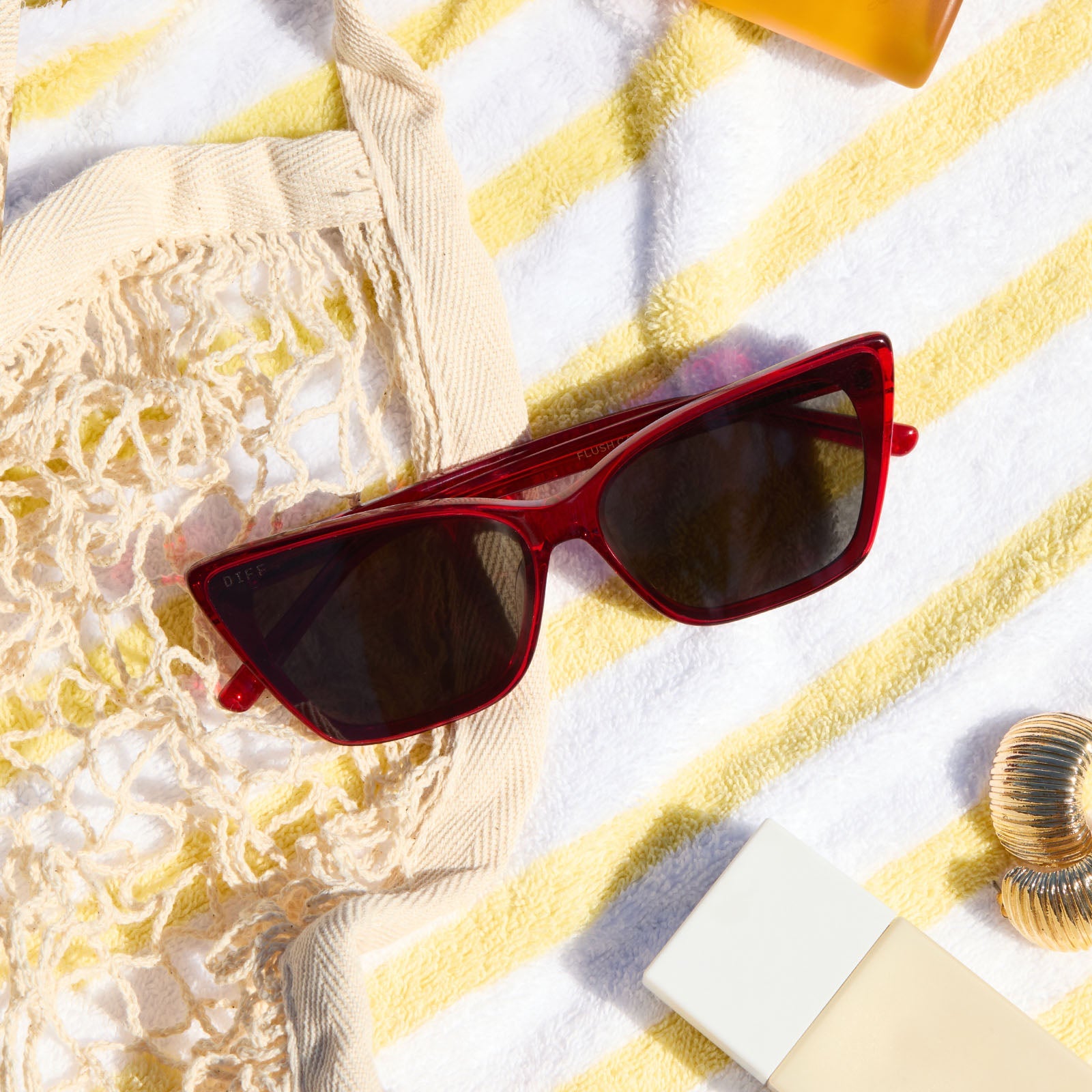lifestyle - diff eyewear featuring the alina red hot summer sunglasses at the beach