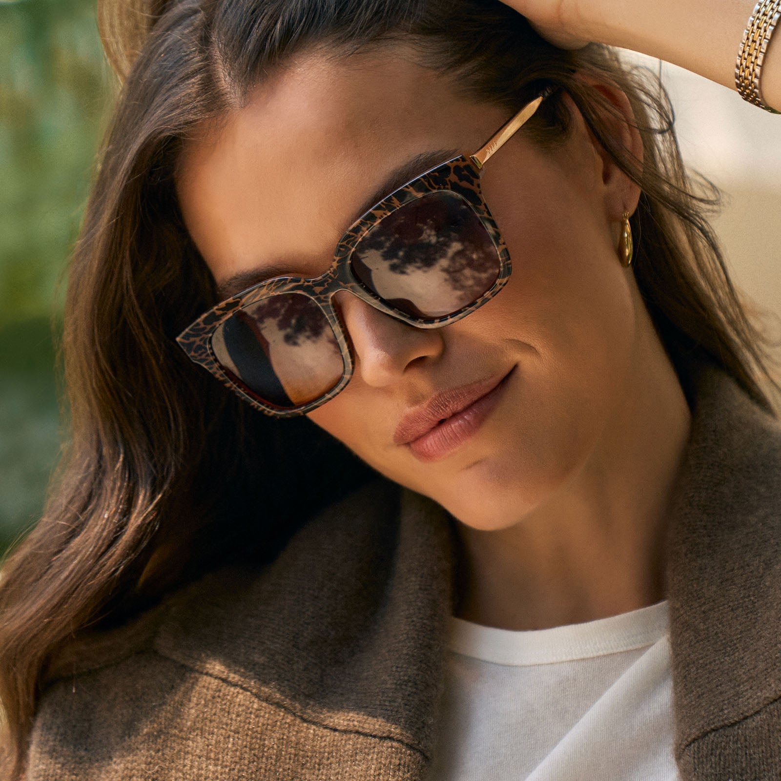 on model - female wearing diff eyewear featuring the bella square sunglasses with a animal print frame and brown gradient lenses angled view