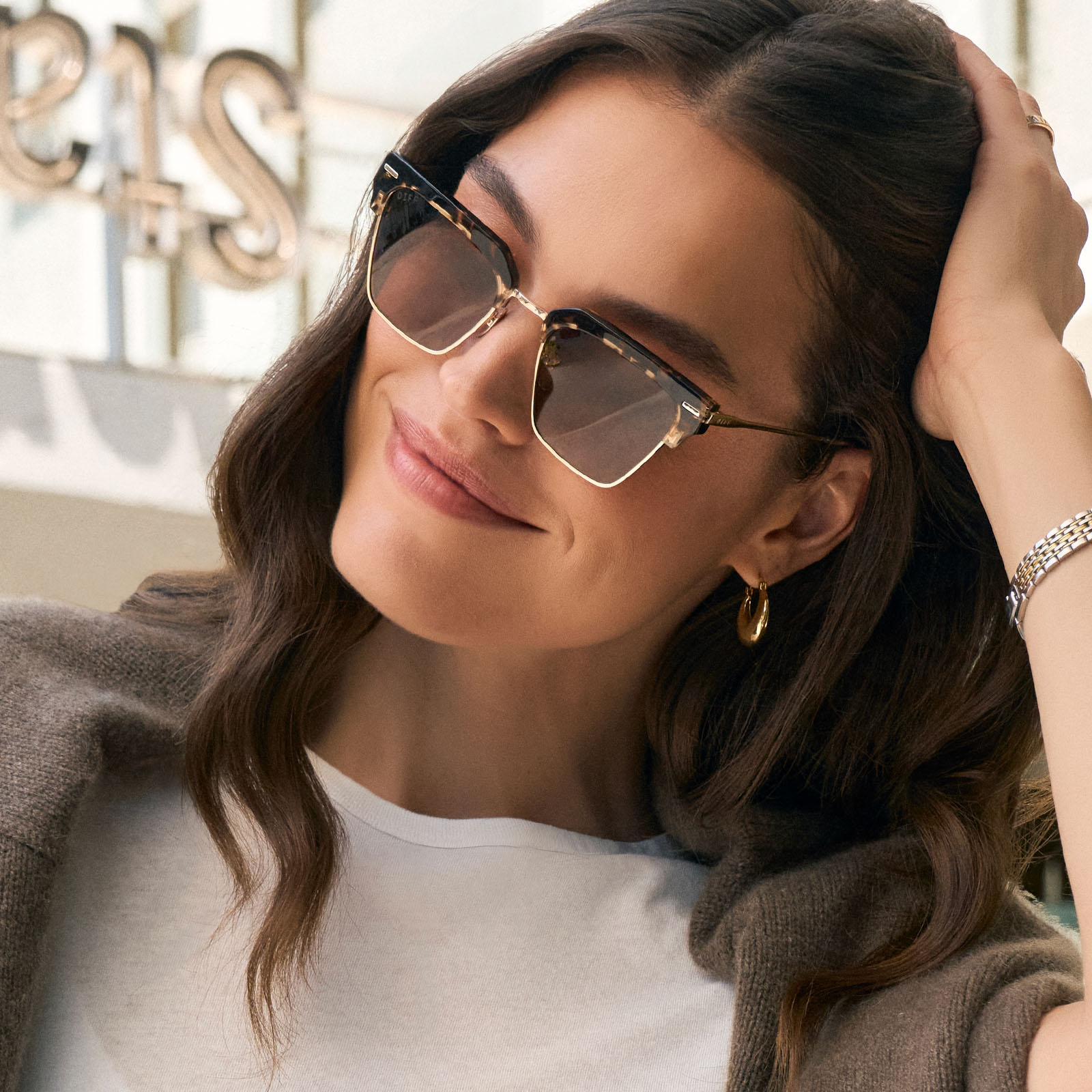 on model - female wearing diff eyewear featuring the capri rectangle sunglasses with a espresso tort frame and brown lenses angled view