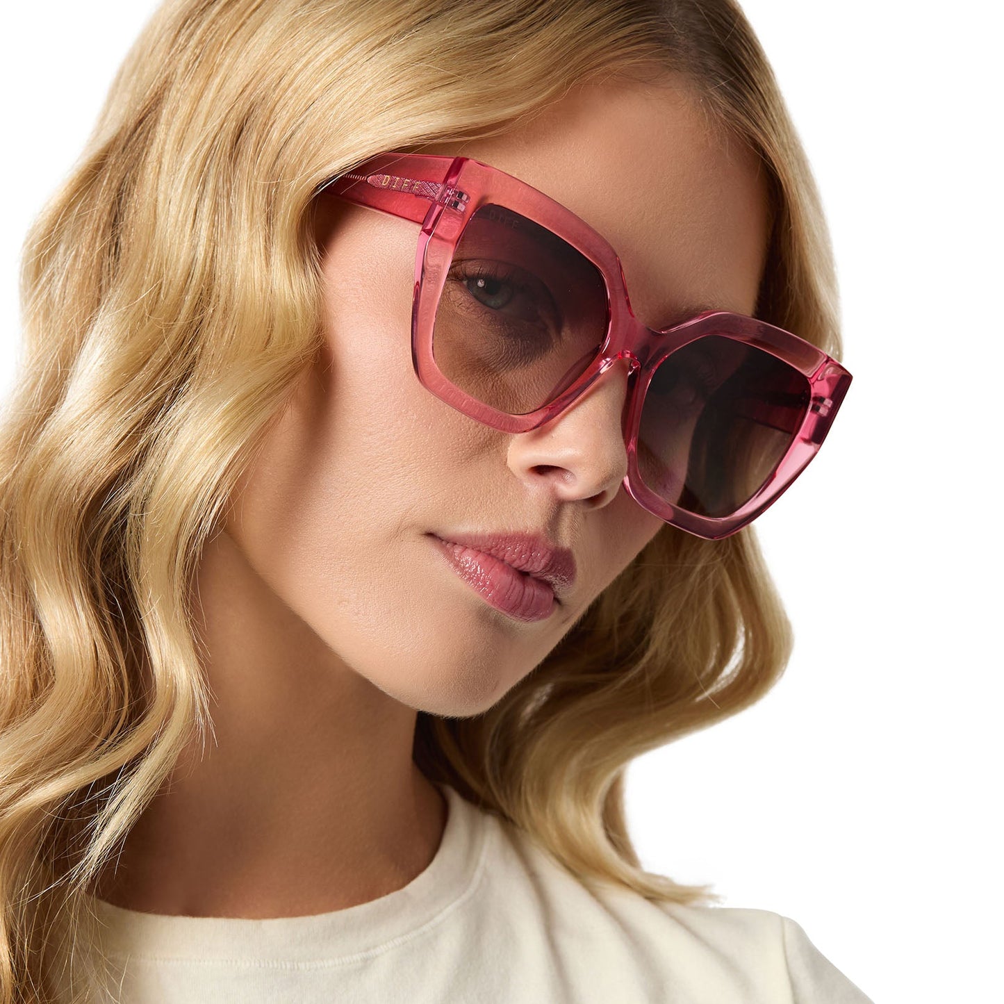 on model - female wearing diff eyewear blaire oversized square sunglasses with a candy pink crystal acetate frame and brown gradient lenses angled view