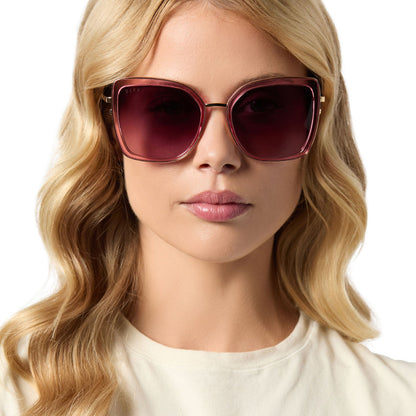 on model - female wearing diff eyewear featuring the clarisse cateye sunglasses with a candy pink crystal frame and wine gradient lenses front view