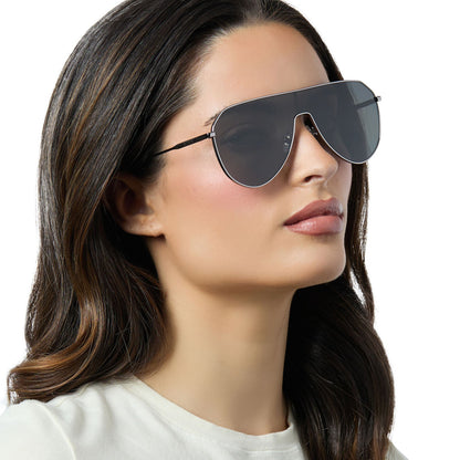 on model - female wearing diff eyewear dash shield oversized sunglasses with a gunmetal metal frame and grey lenses angled view