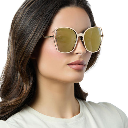 on model - female wearing diff eyewear donna iii oversized square sunglasses with a gold metal frame and gold mirror polarized lenses angled view