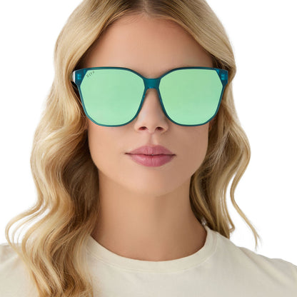 on model - female wearing diff eyewear gia oversized square sunglasses with a turquoise ice crystal acetate frame and turquoise ice mirror lenses front view