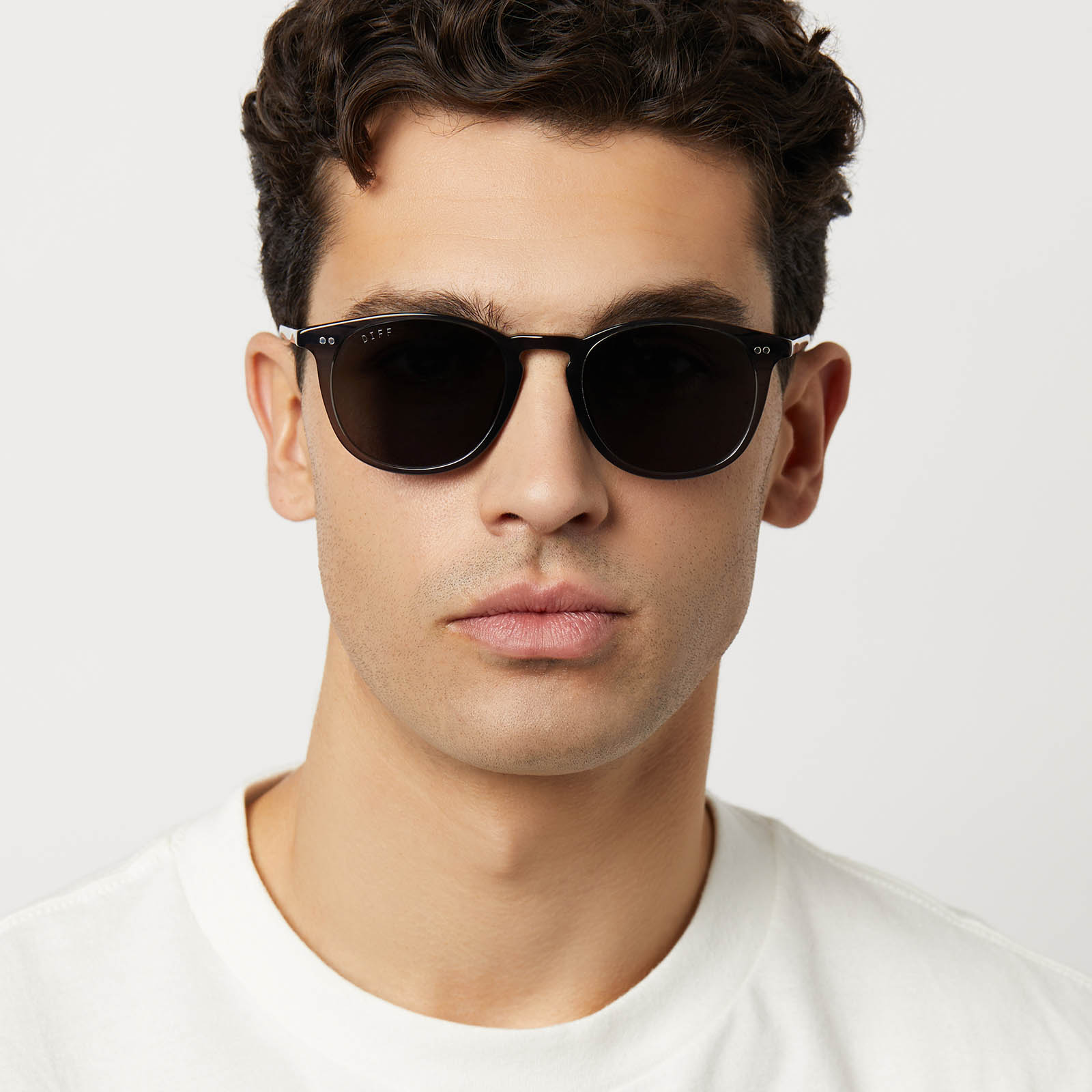 on model - male wearing diff eyewear featuring the jaxson xl square sunglasses with a black smoke crystal frame and grey polarized lenses front view