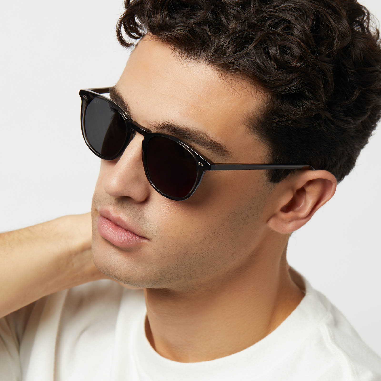 on model - male wearing diff eyewear featuring the jaxson xl square sunglasses with a black smoke crystal frame and grey polarized lenses angled  view