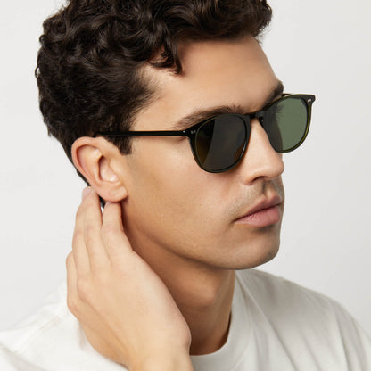 on model - male wearing diff eyewear featuring the jaxson xl square sunglasses with a dark olive crystal frame and g15 polarized lenses angled  view