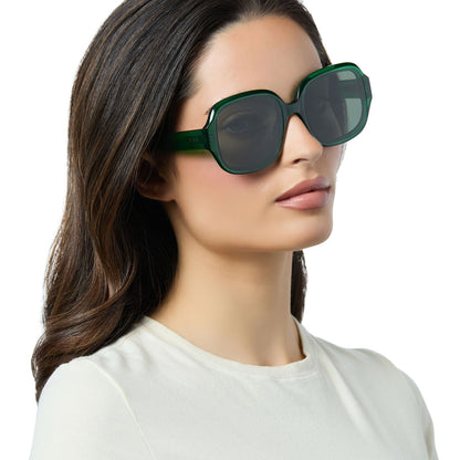 on model - female wearing diff eyewear seraphina round sunglasses with a palm green crystal acetate frame and g15 lenses angled view