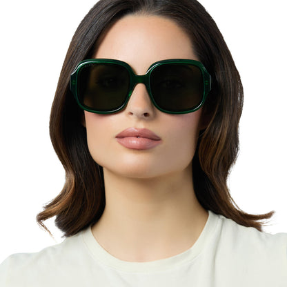 on model - female wearing diff eyewear seraphina round sunglasses with a palm green crystal acetate frame and g15 lenses front view