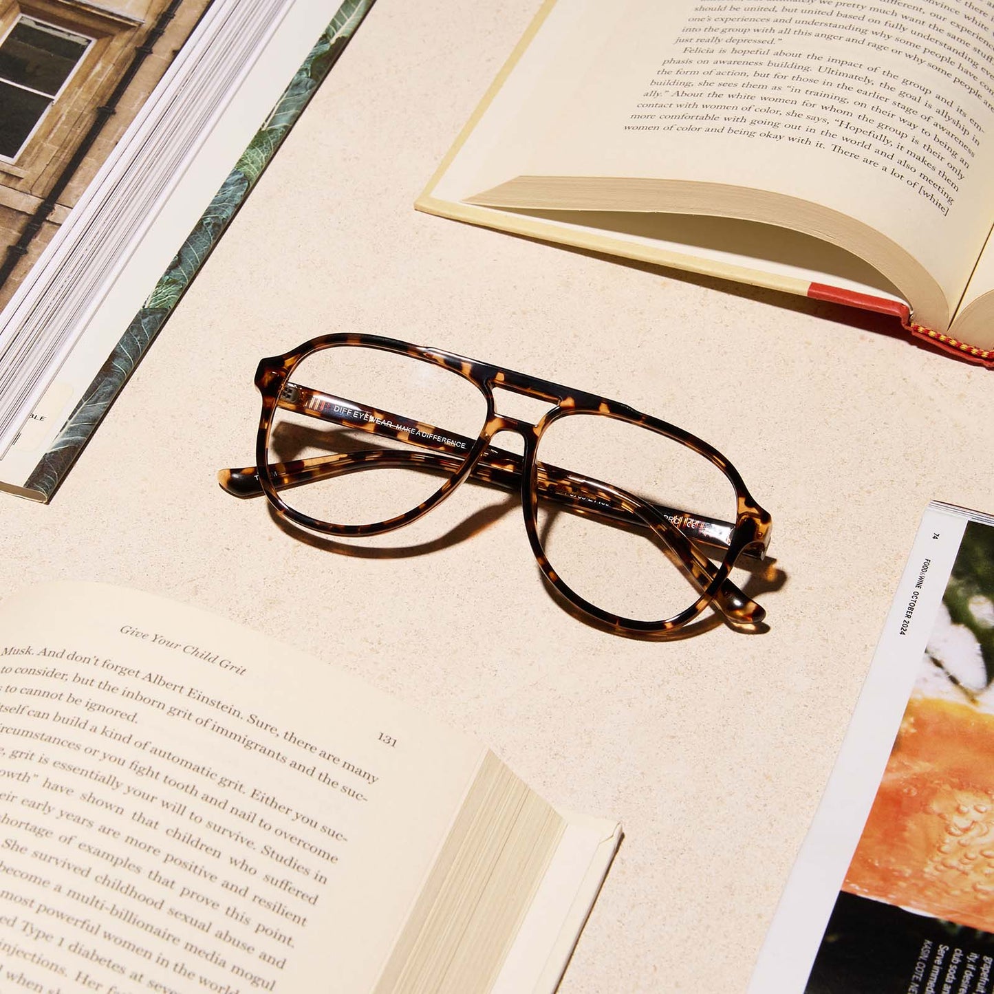 lifestyle - diff eyewear featuring the tatum aviator blue light readers with a espresso tortoise frame laying on a desk