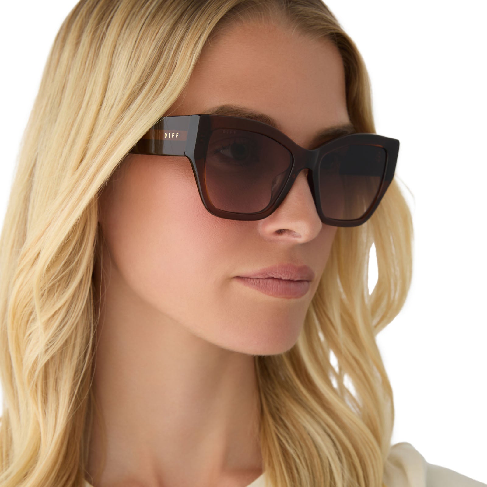 on model - female wearing diff eyewear featuring the vivienne cat eye sunglasses with a whiskey frame and brown gradient polarized lenses angled view